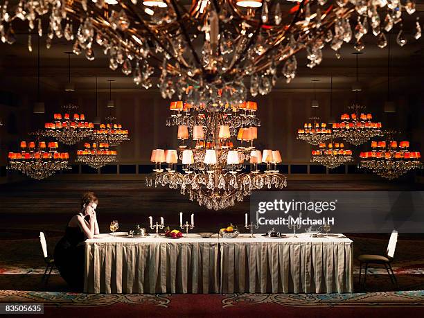 woman sitting on a table - michael lange stock-fotos und bilder