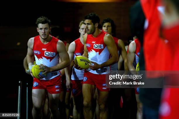 Luke Parker and Josh Kennedy of the Swans lead the team onto the ground at the start of round 22 AFL match between the Adelaide Crows and the Sydney...