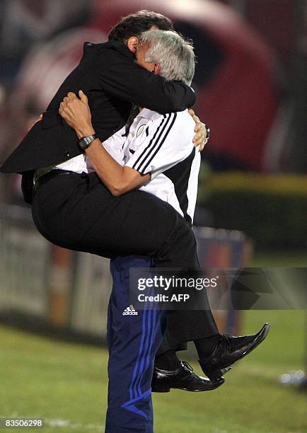 Argentinian Gerardo "Tata" Martino , coach of the Paraguayan national football team, celebrates with an assistent a goal against Peru during their...