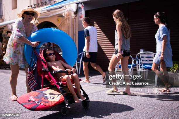 Tourists walk by a closed restaurant next to the spot where five terrorists were shot by police on August 18, 2017 in Cambrils, Spain. Fourteen...