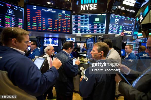 Traders work on the floor of the New York Stock Exchange in New York, U.S., on Friday, Aug. 18, 2017. Stocks were mixed and the S&P 500 Index turned...