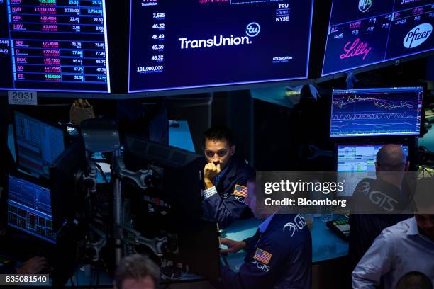 Traders work on the floor of the New York Stock Exchange in New York, U.S., on Friday, Aug. 18, 2017. Stocks were mixed and the S&P 500 Index turned...