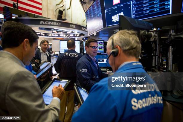 Traders work on the floor of the New York Stock Exchange in New York, U.S., on Friday, Aug. 18, 2017. Stocks were mixed and the S&P 500 Index turned...