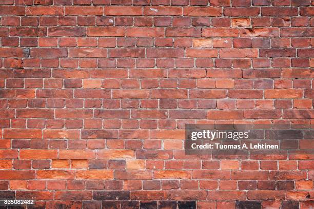 old and aged red brick wall texture background with vignetting. - red wall stockfoto's en -beelden