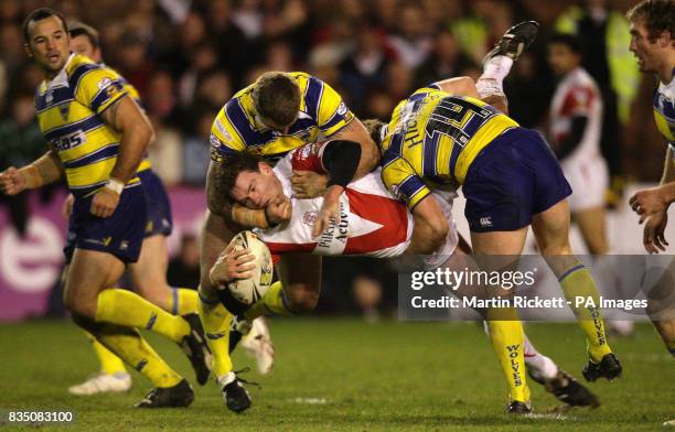 St Helens' Matt Gidley is tackled by Paul Wood and Mickey Higham during the engage Super League match at Knowsley Road, St Helens.