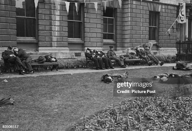 Soldiers in London, exhausted from the VE Day celebrations at the end of World War II, 9th May 1945. Original Publication : Picture Post - 1991 -...