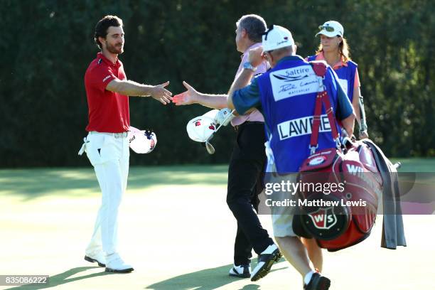 Alejandro Canizares of Spain is is congratulated by Paul Lawrie of Scotland on his win on the 17th green during the 32 qualifiers matches of the...