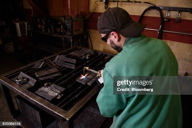 Student demonstrates the process of oxy-fuel cutting during a welding class at the Penn Commercial Business/Technical School in Washington,...