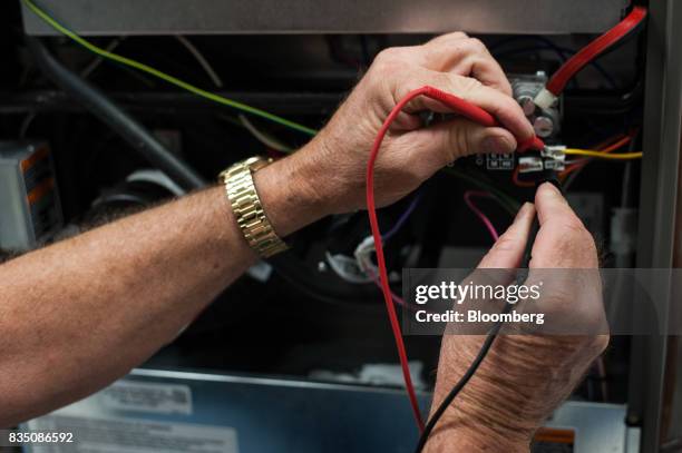 Student demonstrates testing a furnace in a training classroom at the Penn Commercial Business/Technical School in Washington, Pennsylvania, U.S., on...