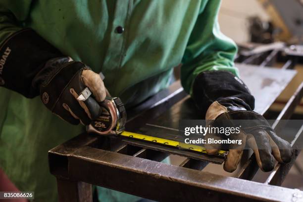 Student measures a piece of steel during a welding class at the Penn Commercial Business/Technical School in Washington, Pennsylvania, U.S., on...