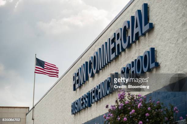 An American flag flies outside the Penn Commercial Business/Technical School in Washington, Pennsylvania, U.S., on Tuesday, Aug. 15, 2017. While...