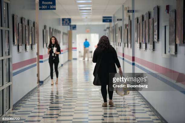 People walk through the hallway of the Penn Commercial Business/Technical School in Washington, Pennsylvania, U.S., on Tuesday, Aug. 15, 2017. While...