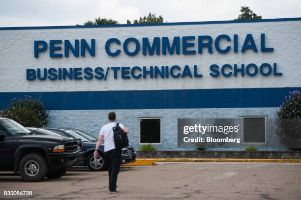 Student walks towards an entrance to Penn Commercial Business/Technical School in Washington, Pennsylvania, U.S., on Tuesday, Aug. 15, 2017. While...