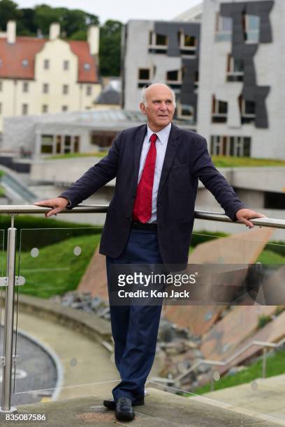 Liberal Democrat leader Vince Cable poses for photographs with the Scottish Parliament in the background ahead of a Scottish Liberal Democrat party...