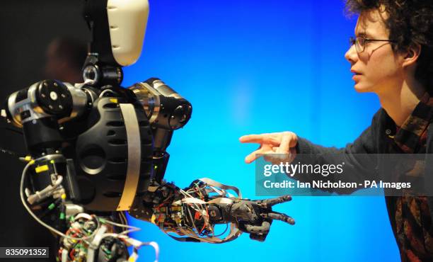 Louis Buckley, Content Developer at London's Science Museum, plays the paper, scissors, stone with Berti the robot at the Science Museum in London.