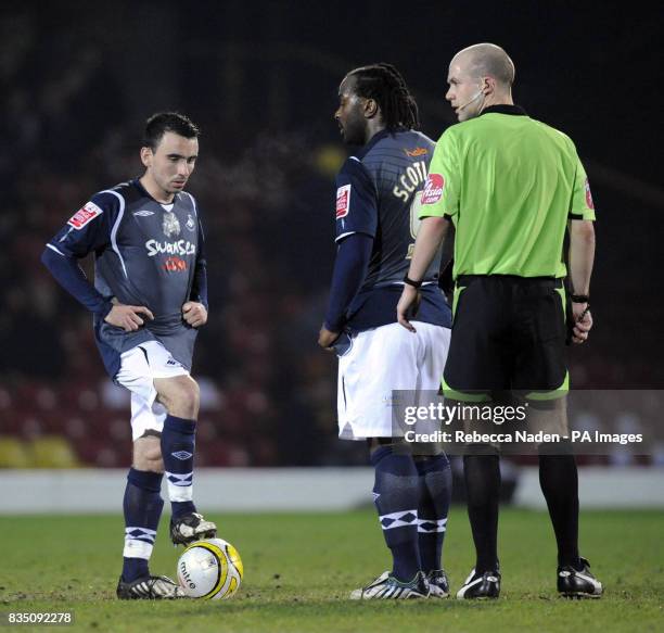 Swansea City's Leon Britton and Jason Scotland wait to re-start the match after conceding their second goal, in the first half during the Coca-Cola...