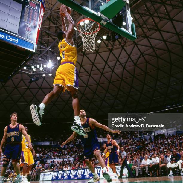 Eddie Jones of the Los Angeles Lakers dunks against the Denver Nuggets during a preseason game on October 10, 1996 at the Stan Sheriff Center in...