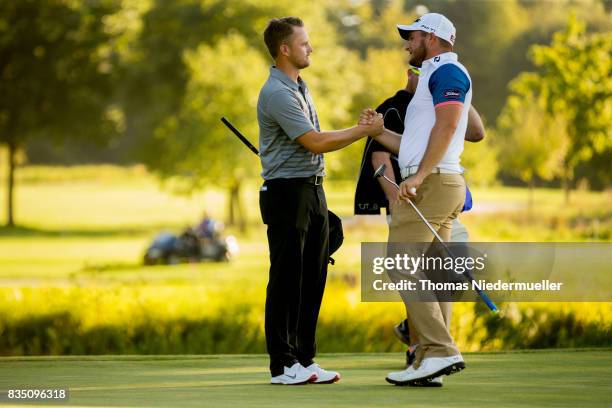 Tom Lewis of England shake hands with Zander Lombard of South Africa during day two of the Saltire Energy Paul Lawrie Matchplay at Golf Resort Bad...