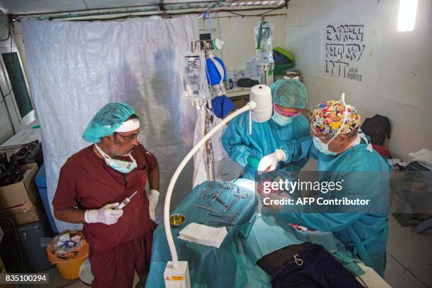 Surgeons from the International Committee of the Red Cross operate on a man with an amputation due to a gunshot wound at a clinic in Old Fangak,...