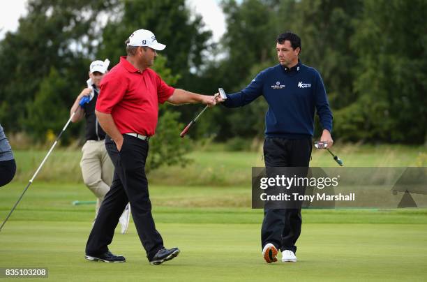 Richard O'Hanlon of St Kew Golf Club and Michael Watson of Wessex Golf Centre celebrate a birdie putt on the 12th green during the Golfbreaks.com PGA...