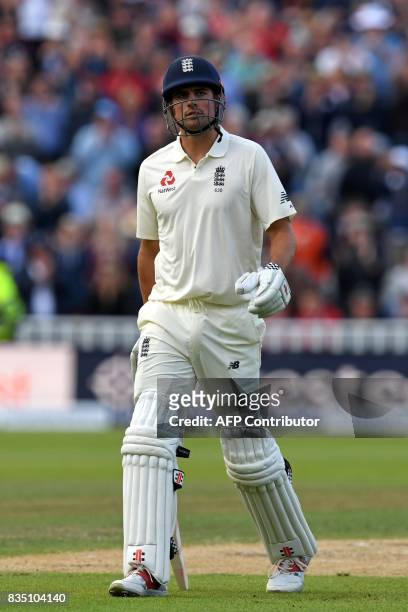 England's Alastair Cook leaves the field after losing his wicket for 243 during play on day 2 of the first Test cricket match between England and the...