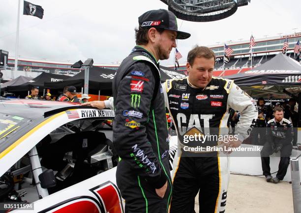 Kurt Busch, driver of the Monster Energy/Haas Automation Ford, talks with Ryan Newman, driver of the Caterpillar Chevrolet, during practice for the...