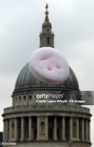 An art installation of smiley faces made of helium, soap and vegetable dyes float over the Tate Modern and London's Southbank by British artist...