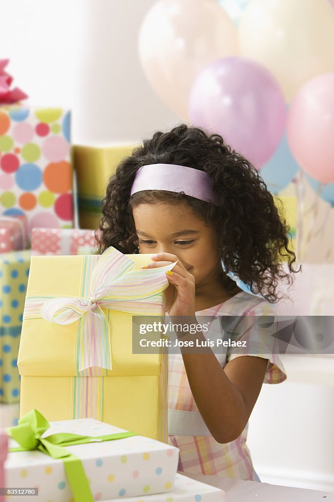 Young girl peeking into birthday present