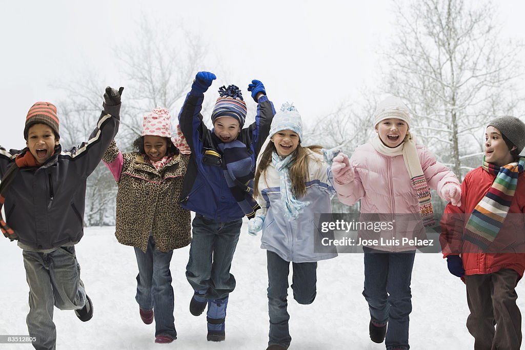 Six children running in the snow