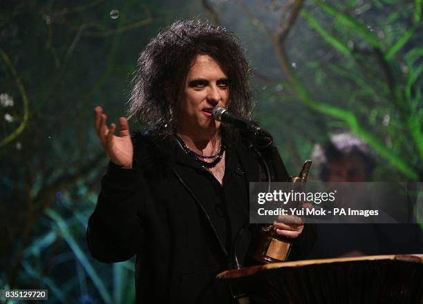 Robert Smith of The Cure receiving The Godlike Geniuses award on stage during the Shockwaves NME Awards 2009 at the 02 Academy, Brixton, London