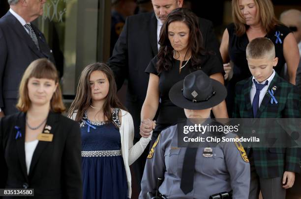 Virginia State Police Trooper-Pilot Berke M.M. Bates' family, wife Amanda and 11-year-old twin son and daughter, leave Saint Paul's Baptist Church...