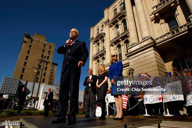 Republican presidential nominee Sen. John McCain addresses a campaign rally as Sen. Lindsey Graham , daughter Meghan McCain, and wife Cindy McCain...