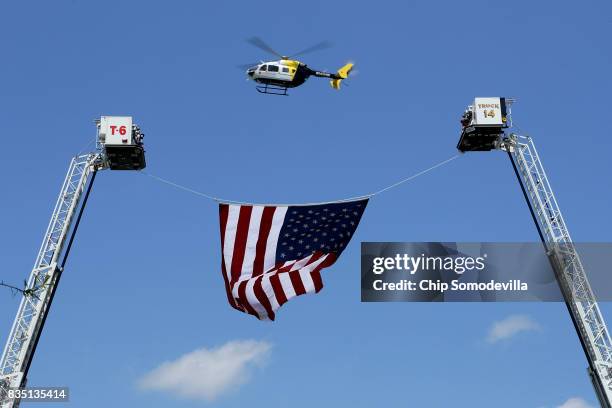 One of a dozen law enforcement helicopters flys over the funeral of Trooper-Pilot Berke M.M. Bates at Saint Paul's Baptist Church August 18, 2017 in...