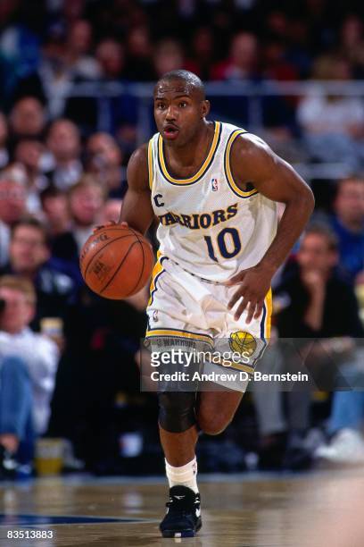 Tim Hardaway of the Golden State Warriors dribbles during a game played in 1991 at the Oakland Coliseum in Oakland, California. NOTE TO USER: User...