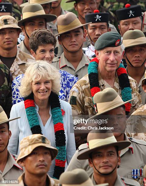 Camilla, Duchess of Cornwall and Prince Charles, Prince of Wales pose for a photograph with Gurkhas after being given garlands at the British...