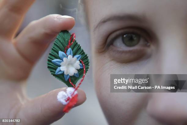 Olesea Stamati, a volunteer from the Association of the Moldovan Community in Ireland hands out flowers in the Temple Bar, Dublin, to mark the...