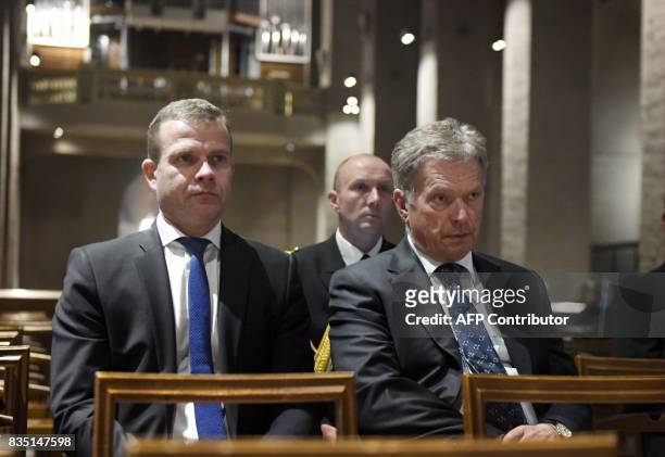 President of Finland Sauli Niinisto and Finland's Minister of Finance Petteri Orpo attend a prayer service at the Turku Cathedral for the victims of...