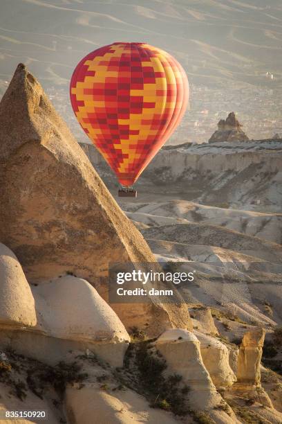 balloon over valleys of cappadocia in background, aerial view - cappadocia stock pictures, royalty-free photos & images