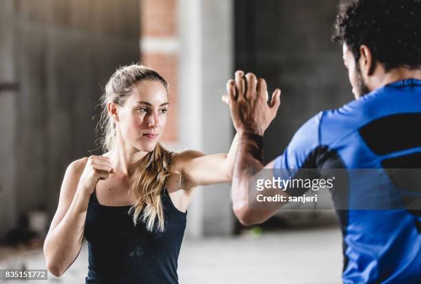 female athlete practicing with trainer - women's self defense stock pictures, royalty-free photos & images
