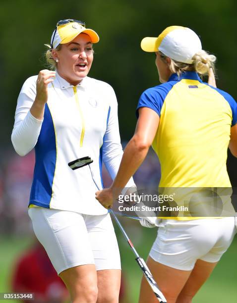 Mel Reid and Charley Hull of Team Europe celebrate during the morning foursomes matches of The Solheim Cup at Des Moines Golf and Country Club on...