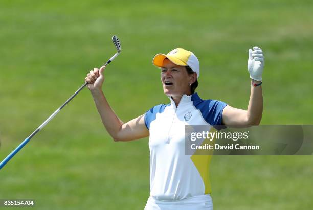 Catriona Matthew of Scotland and the European Team reacts to almost holing her second shot from a difficult position in a bunker on the 17th hole in...