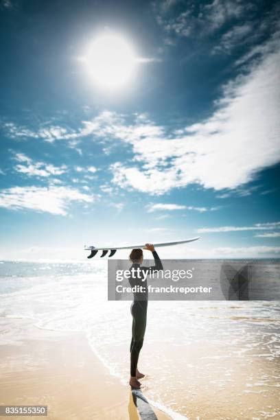 surfer walking in surfers paradise beach in australia - surfers paradise stock pictures, royalty-free photos & images