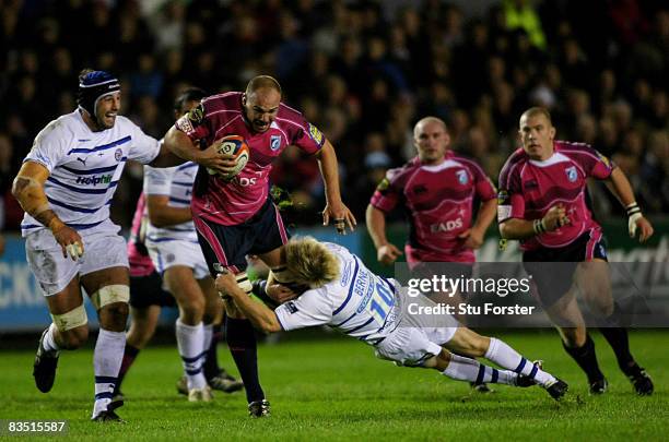 Cardiff Blues forward Mark Lewis breaks the tackle of Shaun Berne of Bath during the EDF Energy Group B Cup Match between Cardiff Blues and Bath...