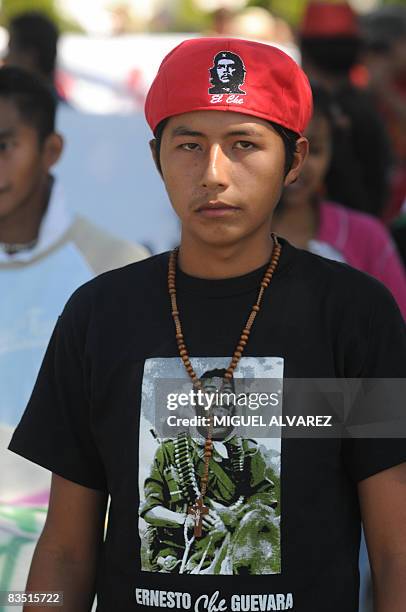 Student wearing a tee-shirt and a beret showing Che Guevara demonstrates with others in the streets of San Salvador to demand measures to help young...