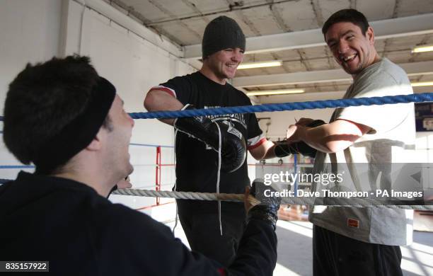 Trainer Anthony Farnell shares a joke with Steve Bell and Frankie Gavin during a training session at Arnies Gym, Manchester.