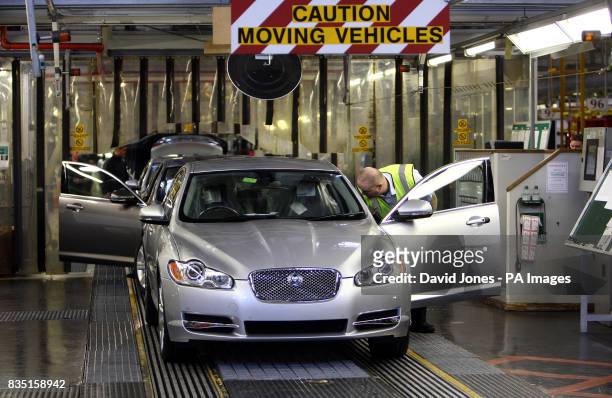 Workers on the final check of the Jaguar XF production line in Castle Bromwich, Birmingham.