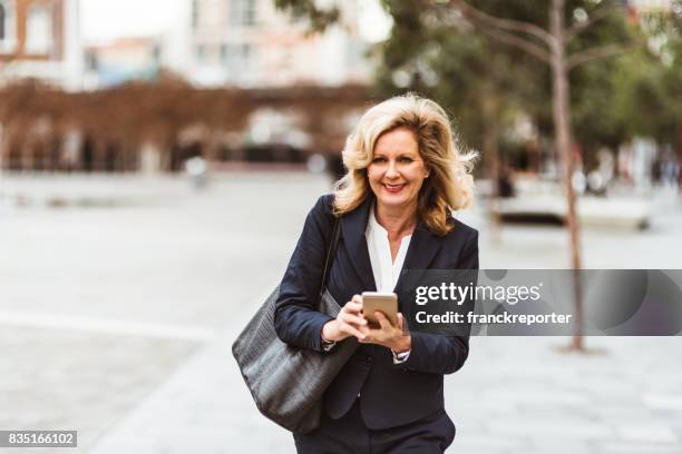 business woman text messaging on the street - 80s business women stock pictures, royalty-free photos & images