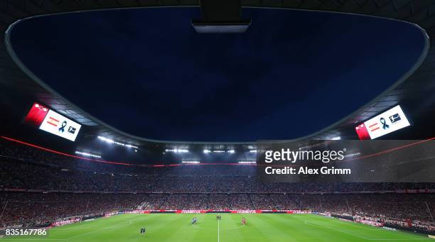 Players and match officials observe a minute's silence in memory of the victims of Thursday's terrorist attacks in Spain during the Bundesliga match...