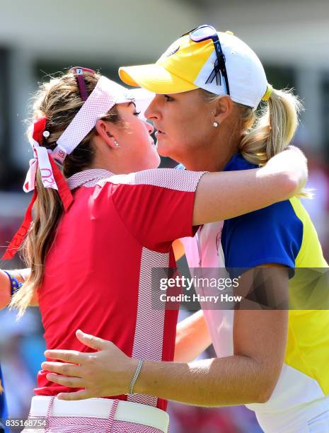 Anna Nordqvist of Team Europe hugs Paula Creamer of Team USA after a two up win on the 17th green during the morning foursomes matches of the Solheim...