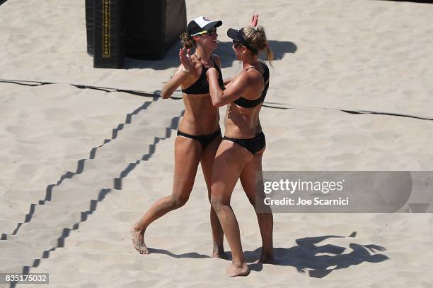 Lauren Fendrick and April Ross celebrate their round 1 win against Juliana Friederich and Danielle Jacobson at the AVP Manhattan Beach Open - Day 2...